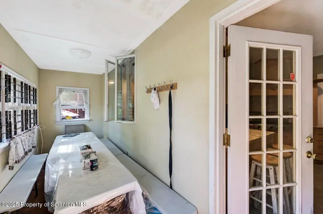 a bedroom with bed and wooden floor