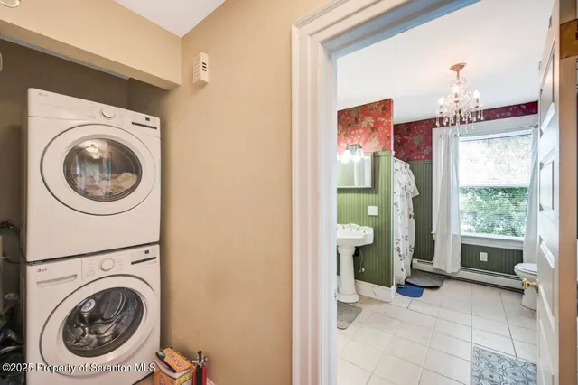 a bedroom with bed and a chandelier