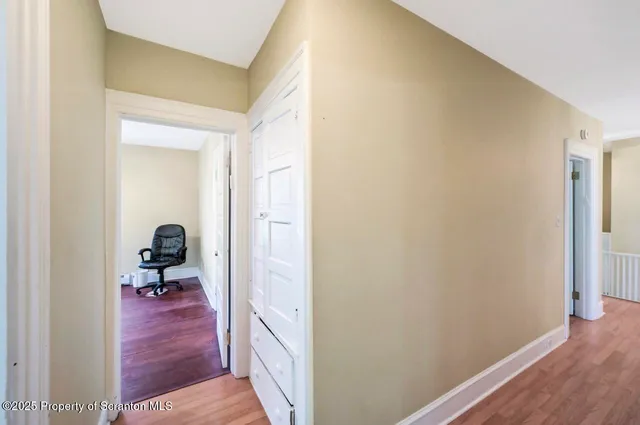 a wooden bench sitting in front of a building