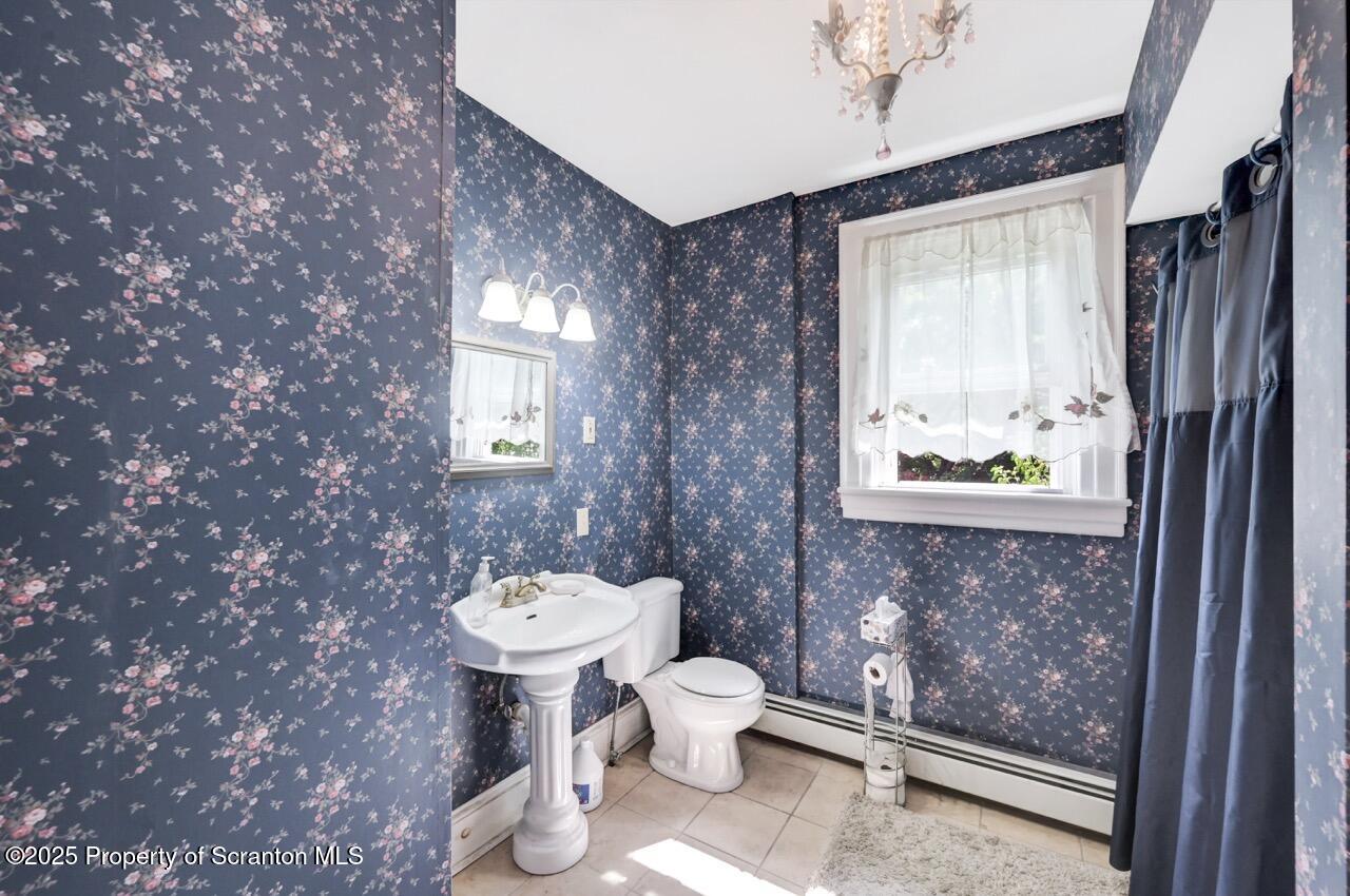 616-618 Harrison Avenue Scranton, PA 18510 - Photo 51 of 73 a bathroom with a toilet sink and mirror