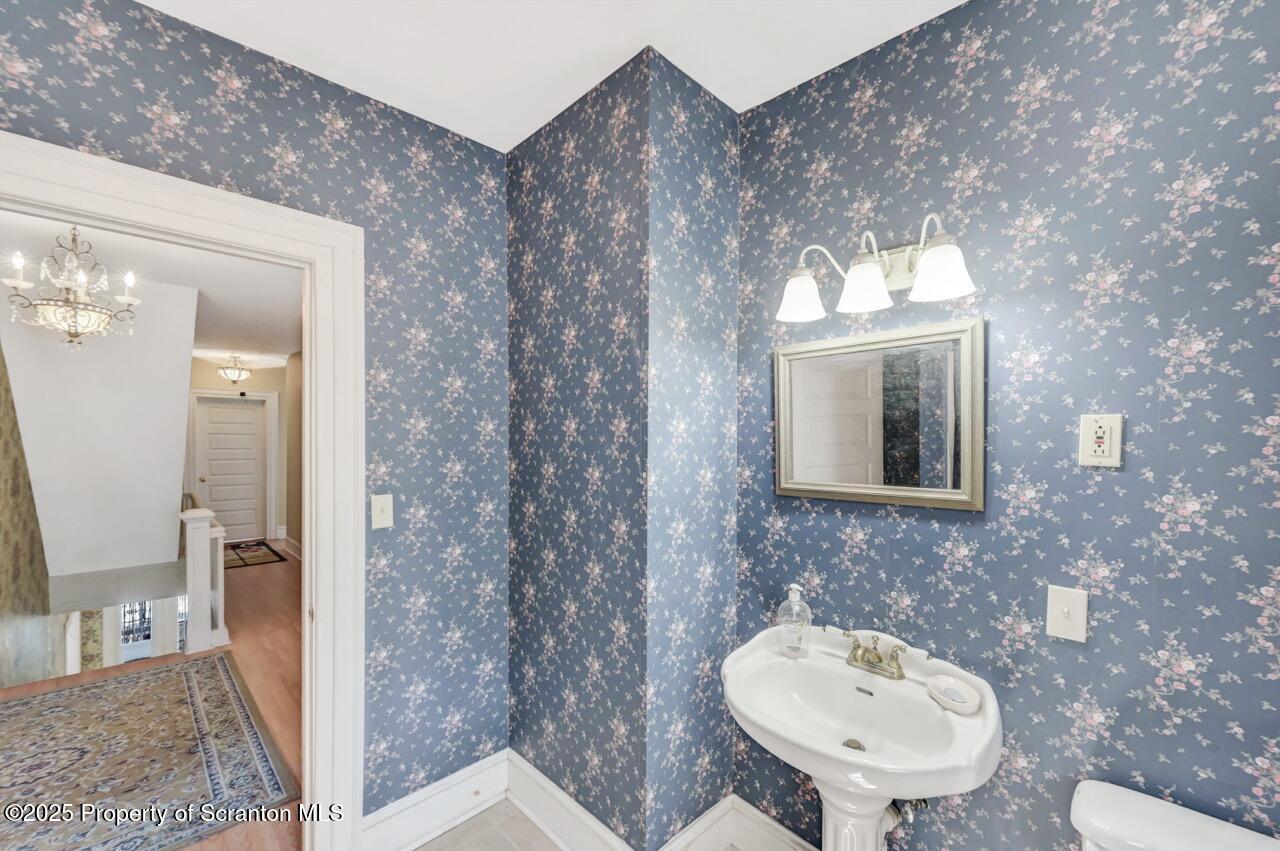 616-618 Harrison Avenue Scranton, PA 18510 - Photo 52 of 73 a bathroom with a toilet sink and mirror