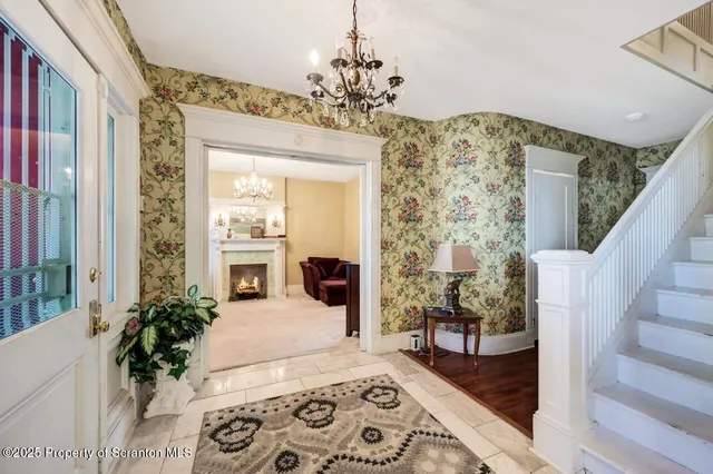 a view of a dining room with furniture a livingroom and chandelier