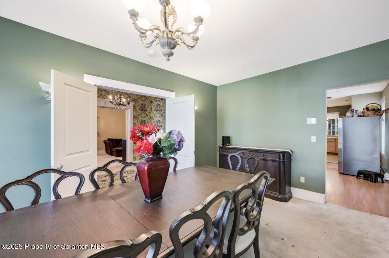 616-618 Harrison Avenue Scranton, PA 18510 - Photo 10 of 73 a view of a dining room with furniture a livingroom and chandelier