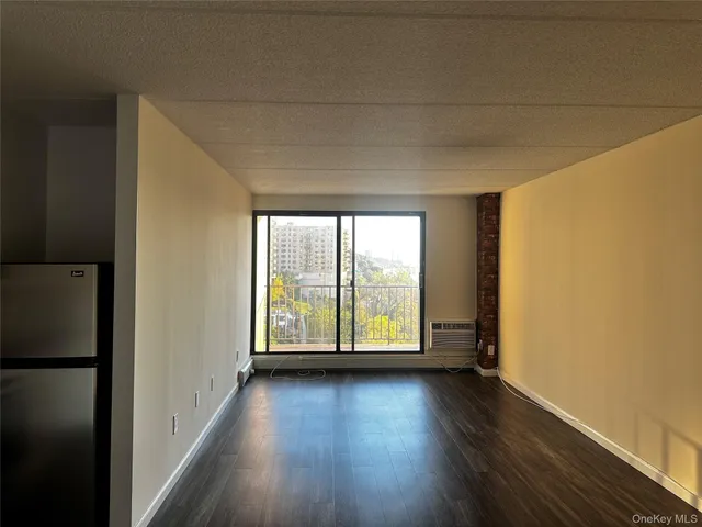 a view of a livingroom with wooden floor and white walls