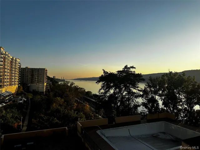 a living room with furniture a table and kitchen view