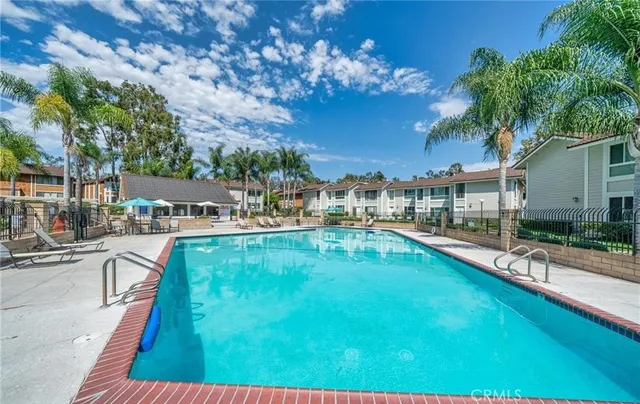 a swimming pool view with a outdoor seating