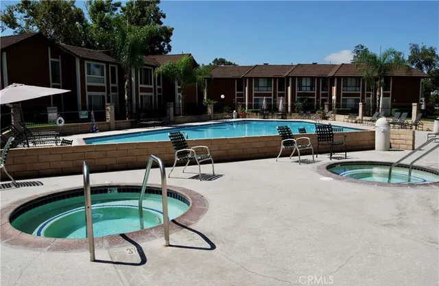 a swimming pool with outdoor seating and yard