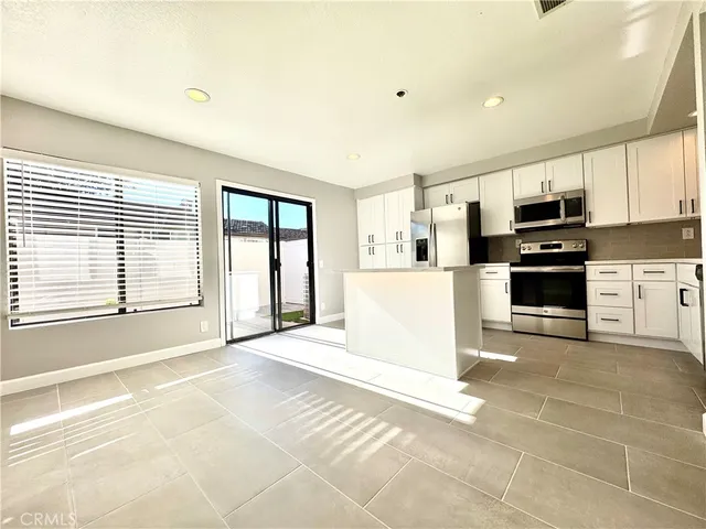 a view of a kitchen with a stove top oven