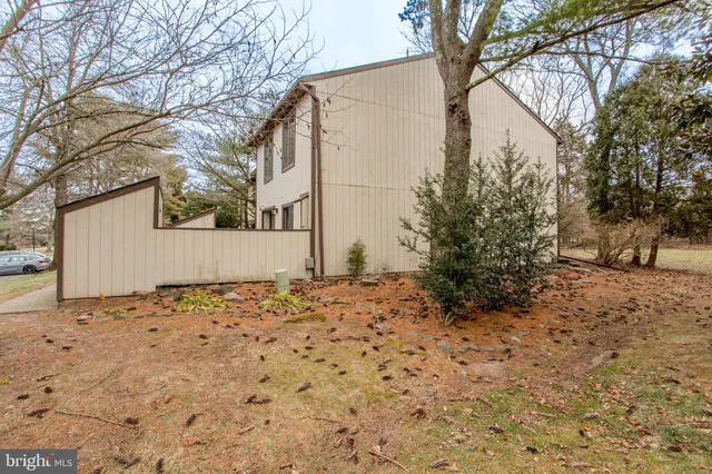 a backyard of a house with large trees