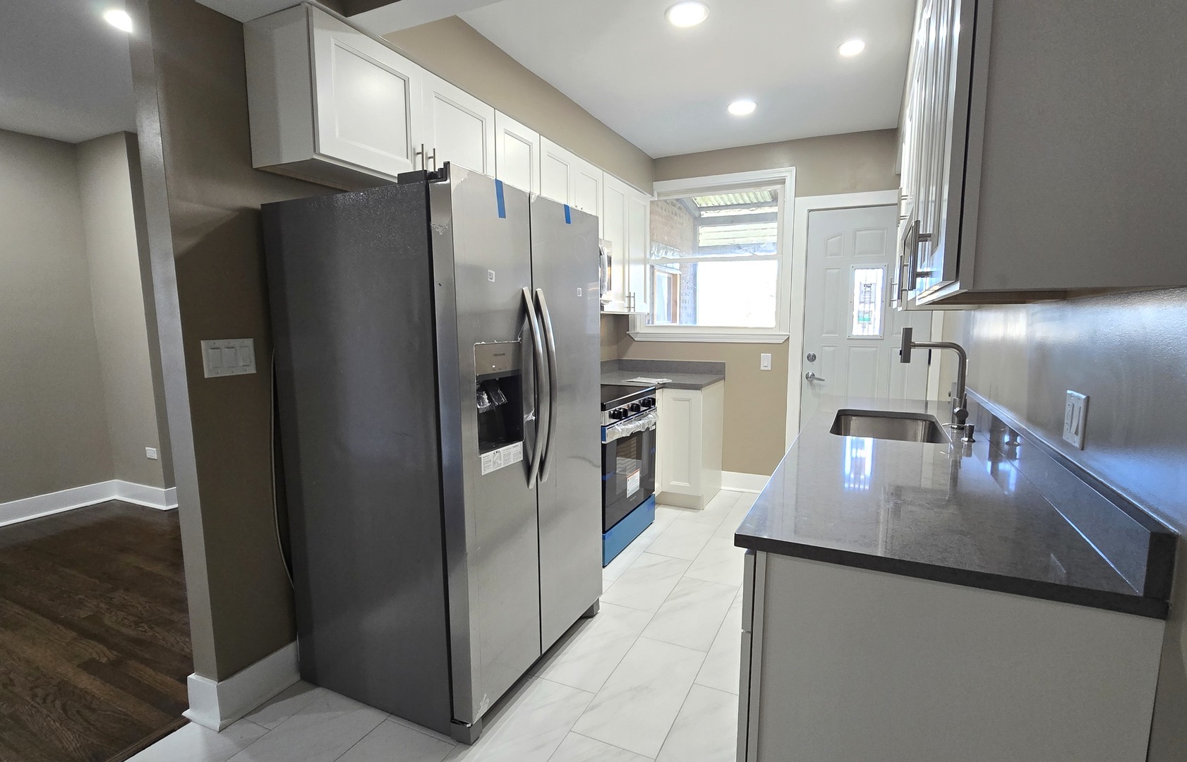 3051 North Austin Avenue, Unit 2F Chicago, IL 60634 - Photo 2 of 9 a kitchen with stainless steel appliances granite countertop a refrigerator a sink and a stove