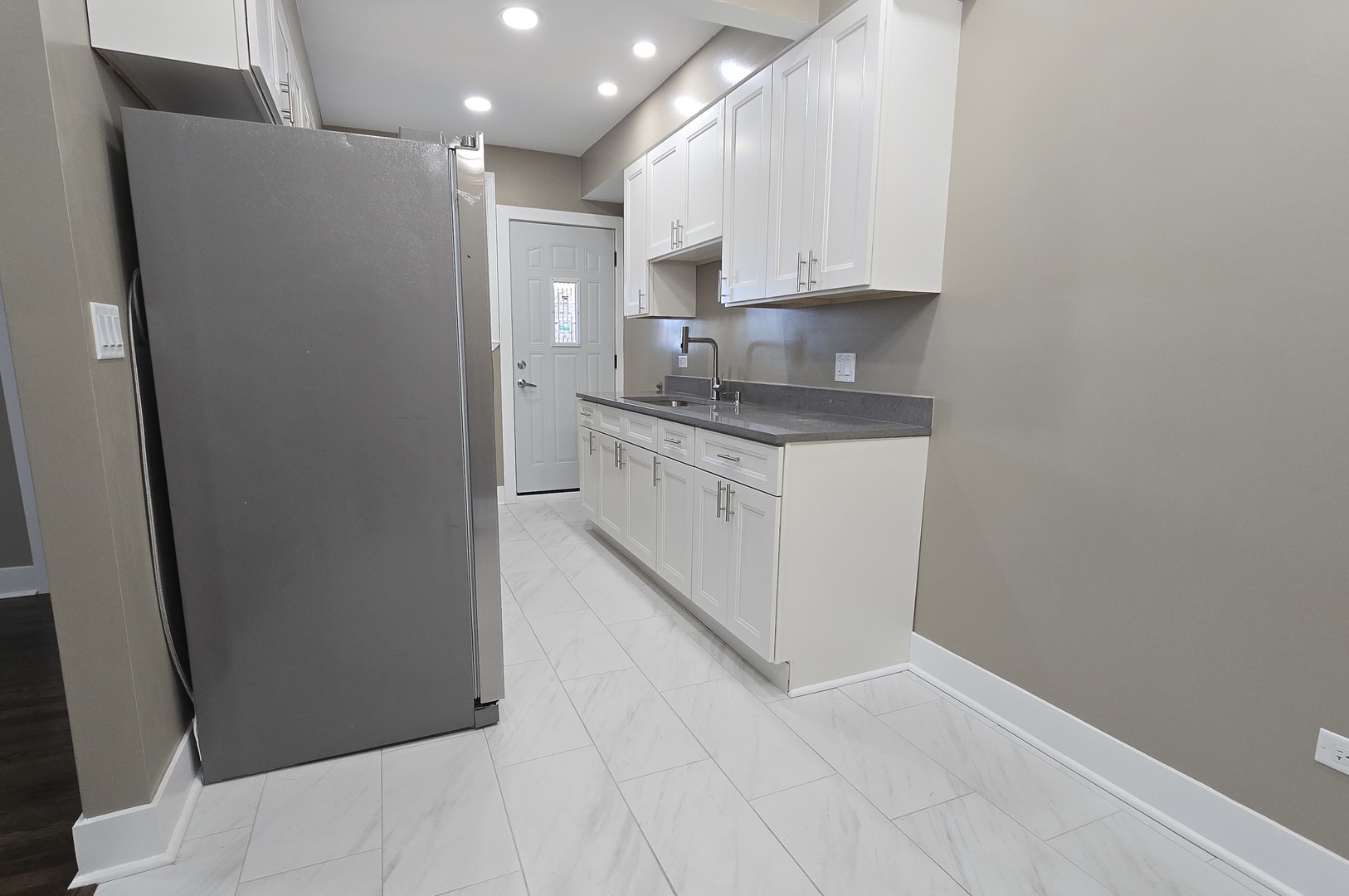 3051 North Austin Avenue, Unit 2F Chicago, IL 60634 - Photo 3 of 9 a kitchen with stainless steel appliances granite countertop a refrigerator and a stove