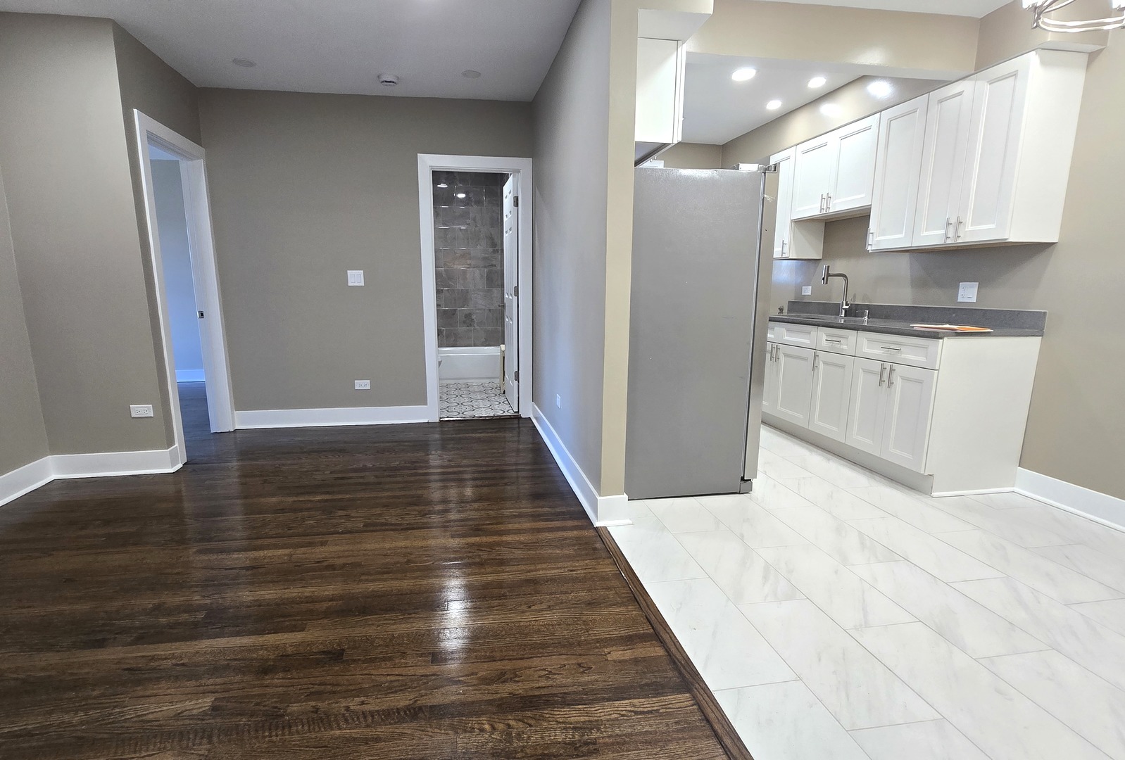 3051 North Austin Avenue, Unit 2F Chicago, IL 60634 - Photo 5 of 9 a view of a kitchen with wooden floor and electronic appliances