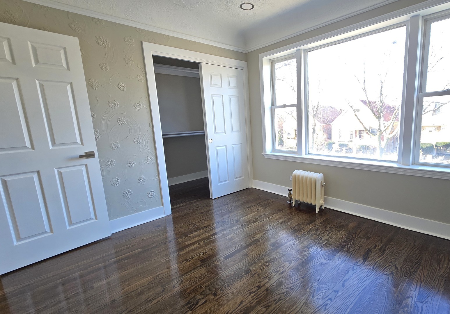 3051 North Austin Avenue, Unit 2F Chicago, IL 60634 - Photo 9 of 9 a view of an empty room with wooden floor and a window