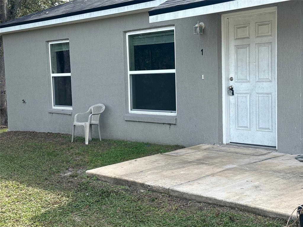 316 Pleasant Grove Road, Unit 2 Inverness, FL 34452 - Photo 2 of 12 a front view of a house with a yard