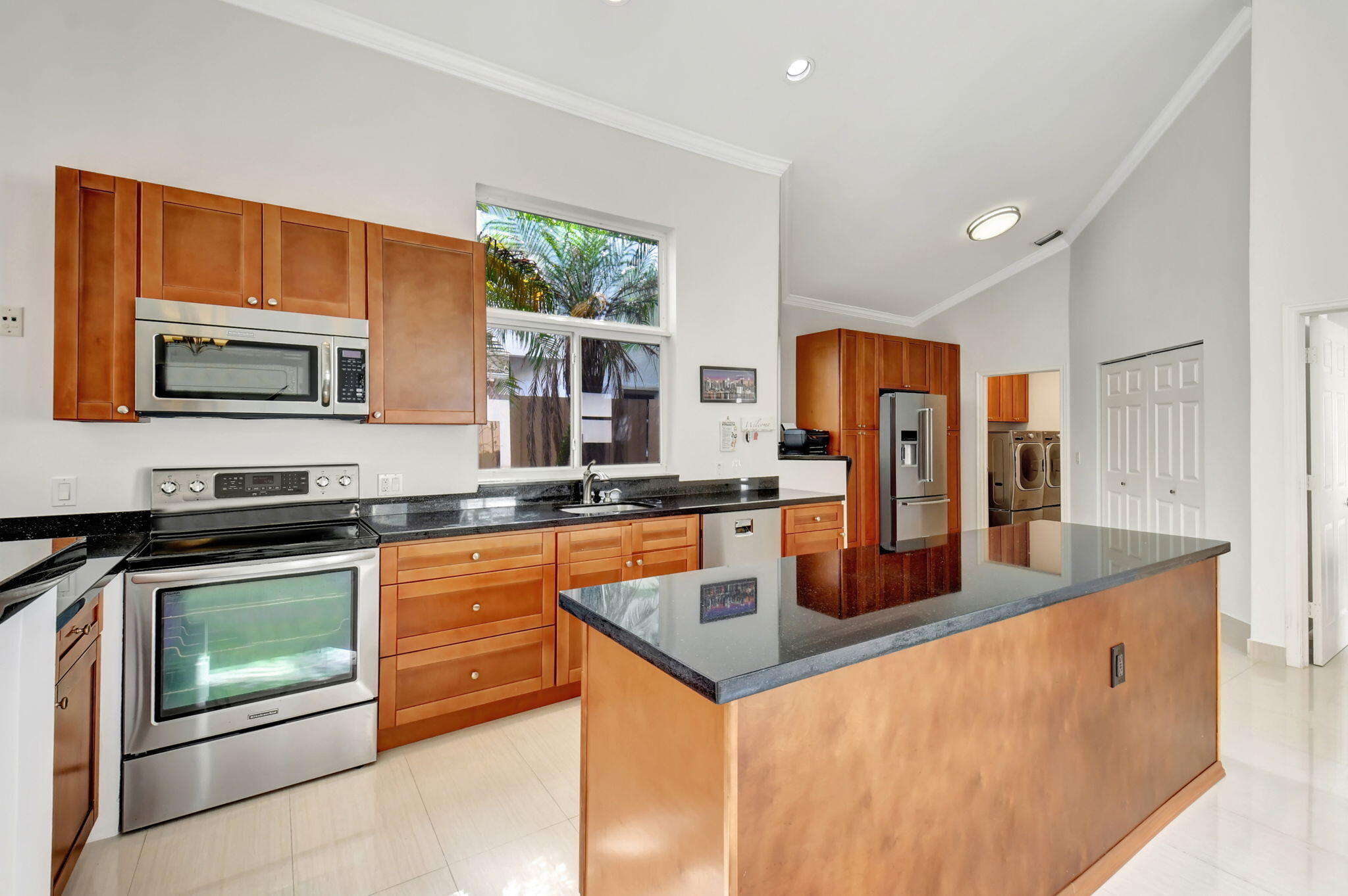 2469 Northwest 66th Drive Boca Raton, FL 33496 - Photo 12 of 45 a kitchen with stainless steel appliances granite countertop a stove a sink and a microwave