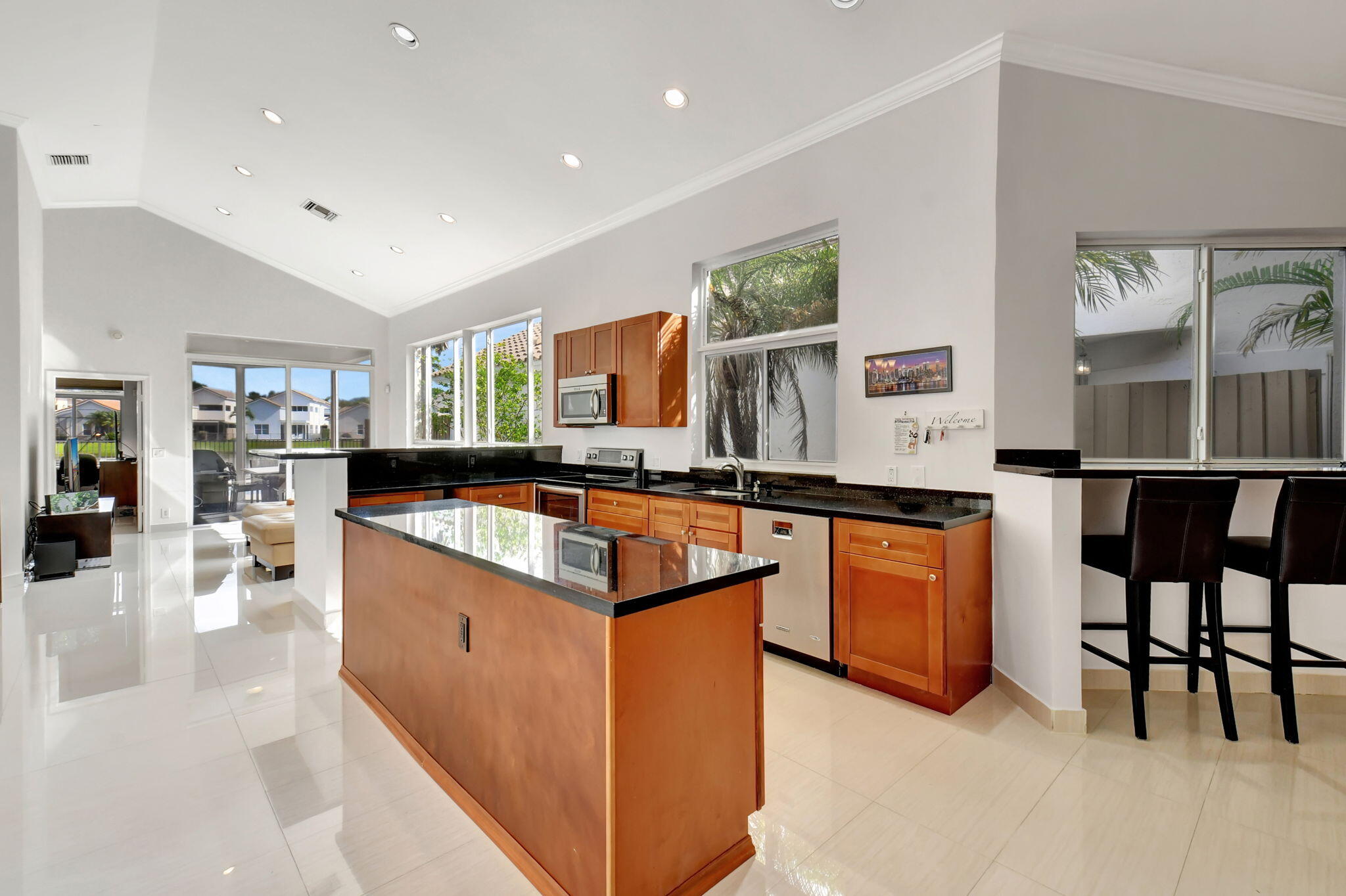 2469 Northwest 66th Drive Boca Raton, FL 33496 - Photo 13 of 45 a large kitchen with granite countertop a large counter top appliances and cabinets
