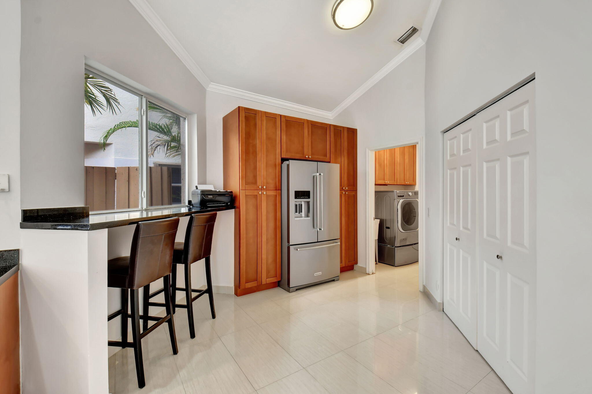 2469 Northwest 66th Drive Boca Raton, FL 33496 - Photo 16 of 45 a view of a kitchen with refrigerator and furniture
