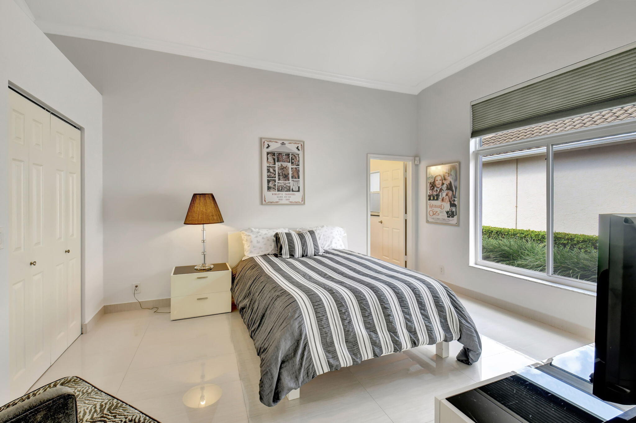 2469 Northwest 66th Drive Boca Raton, FL 33496 - Photo 24 of 45 a bedroom with a bed and a night stand