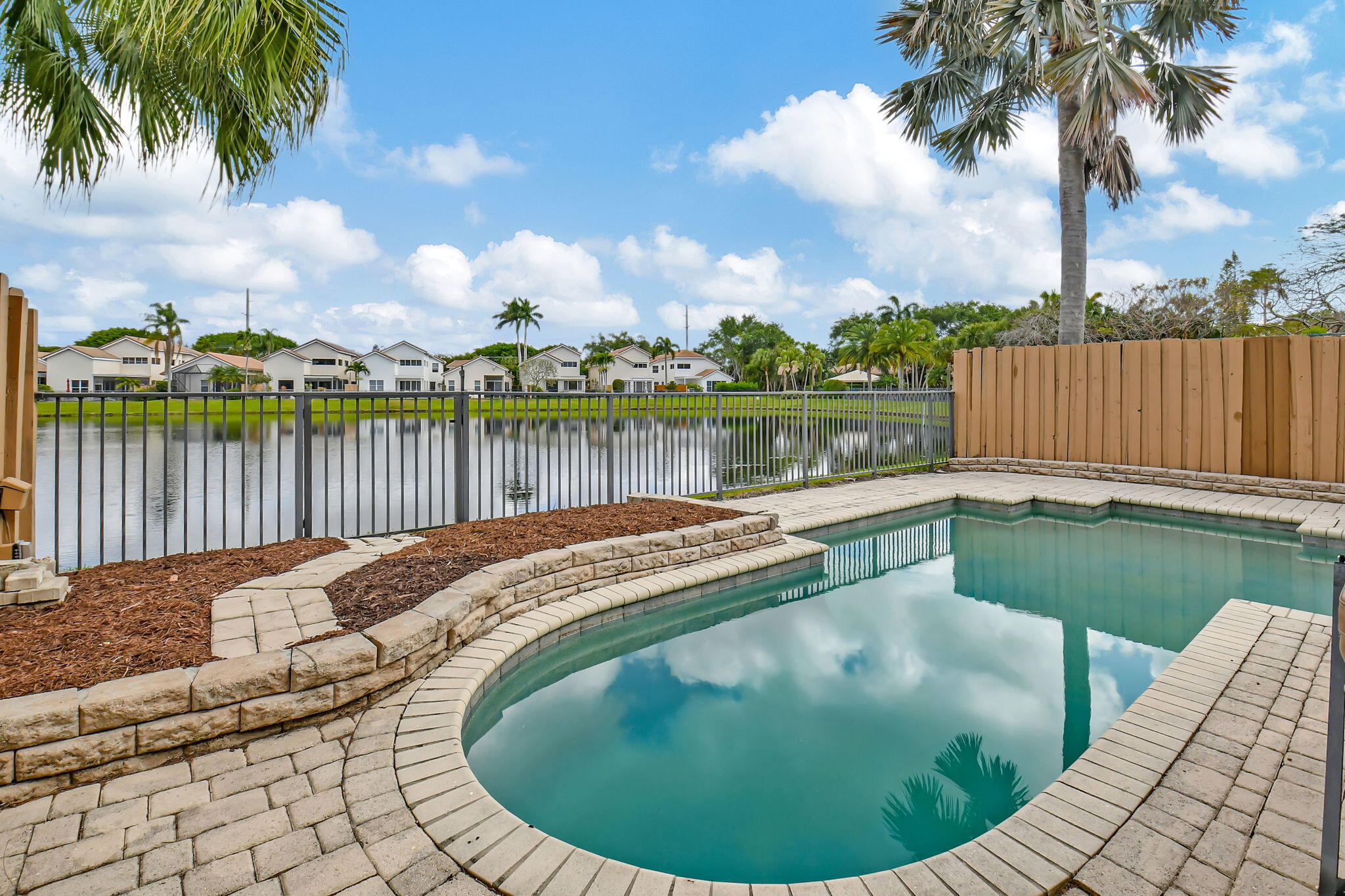2469 Northwest 66th Drive Boca Raton, FL 33496 - Photo 34 of 45 a view of a swimming pool with a lake