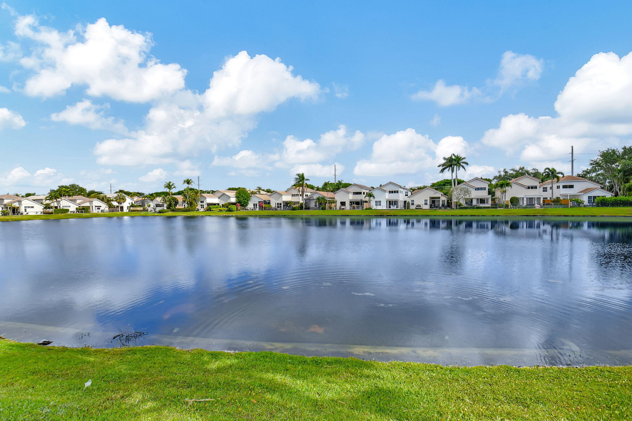 2469 Northwest 66th Drive Boca Raton, FL 33496 - Photo 37 of 45 a view of a lake with houses in the back
