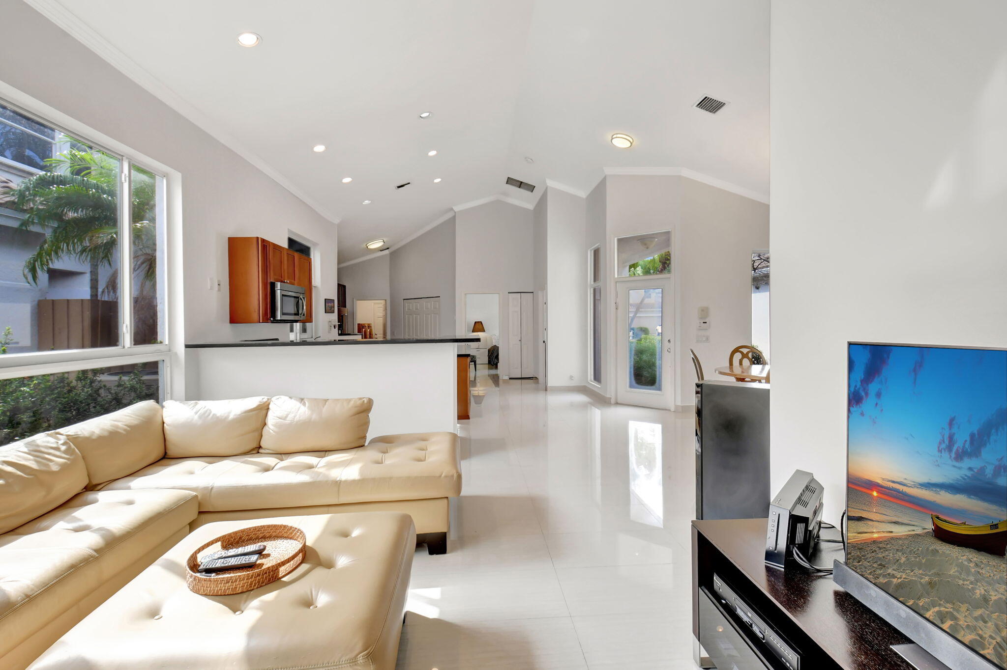 2469 Northwest 66th Drive Boca Raton, FL 33496 - Photo 7 of 45 a living room with stainless steel appliances furniture a rug and a large window