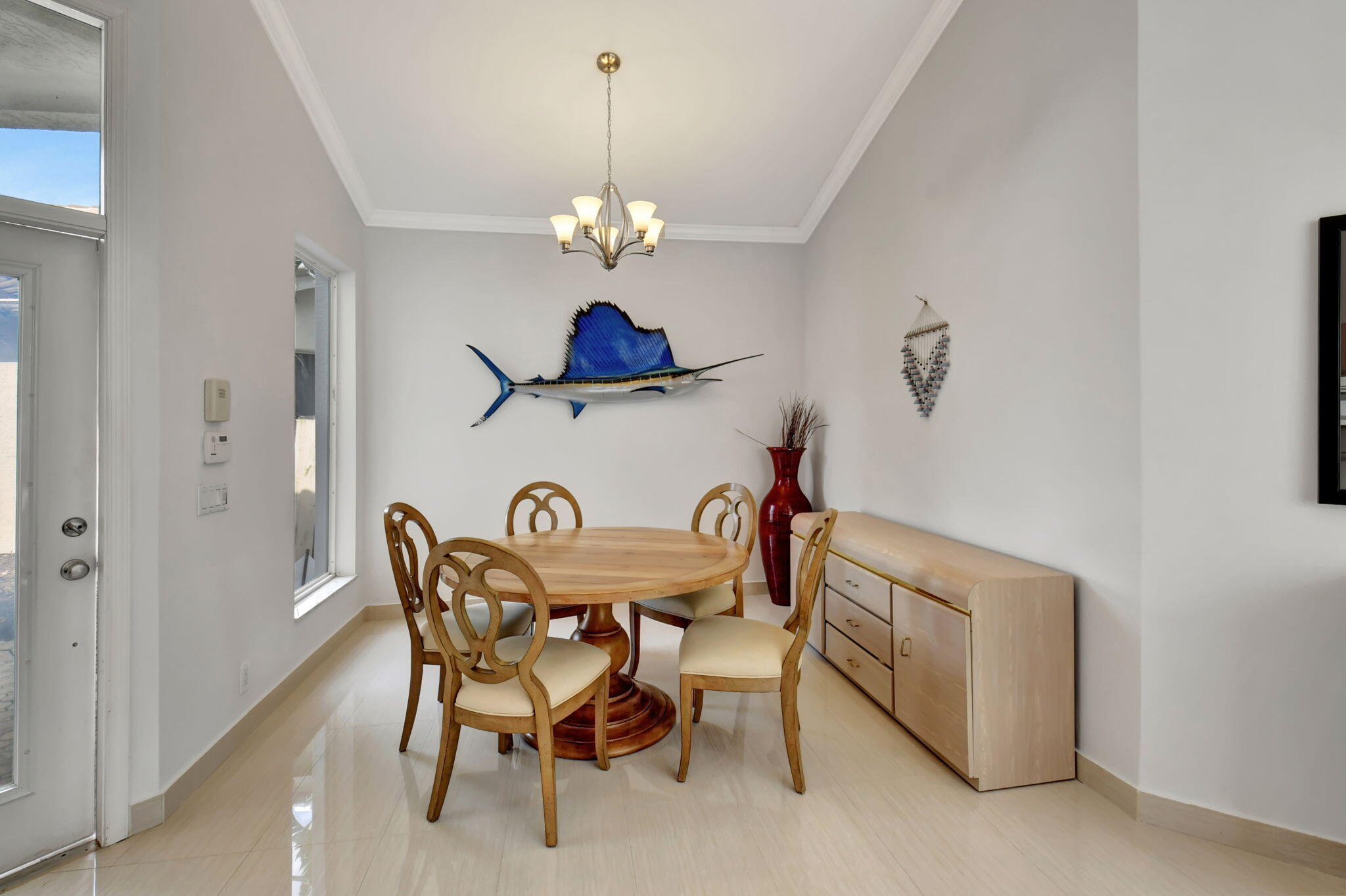 2469 Northwest 66th Drive Boca Raton, FL 33496 - Photo 9 of 45 a view of a dining room with furniture and chandelier