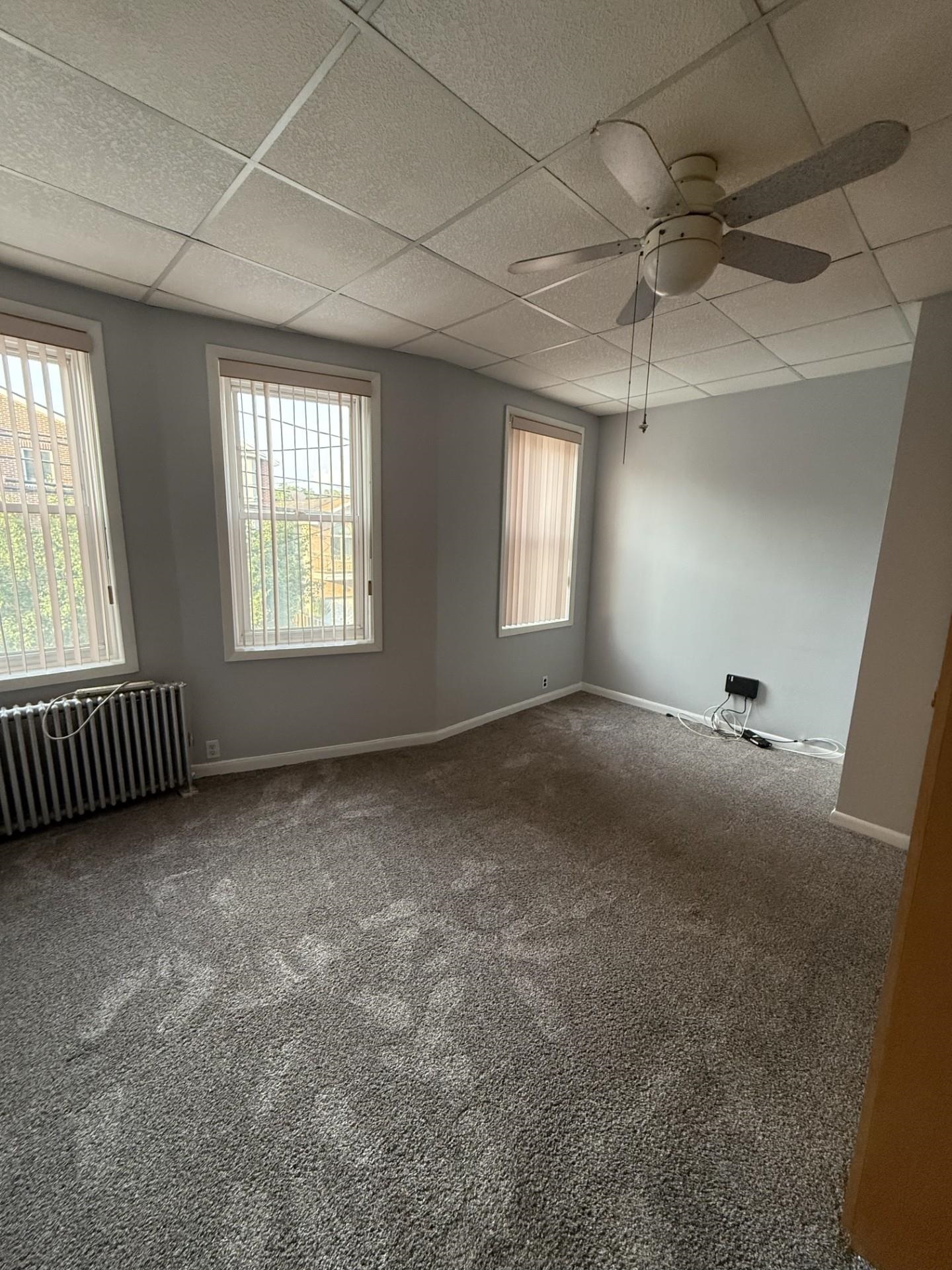 169 Beacon Avenue, Unit 2 Jersey City, NJ 07306 - Photo 3 of 9 a view of a livingroom with a ceiling fan and window