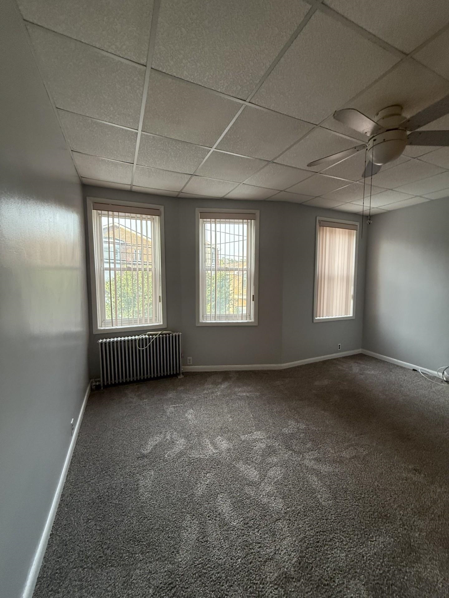 169 Beacon Avenue, Unit 2 Jersey City, NJ 07306 - Photo 4 of 9 a view of an empty room with windows