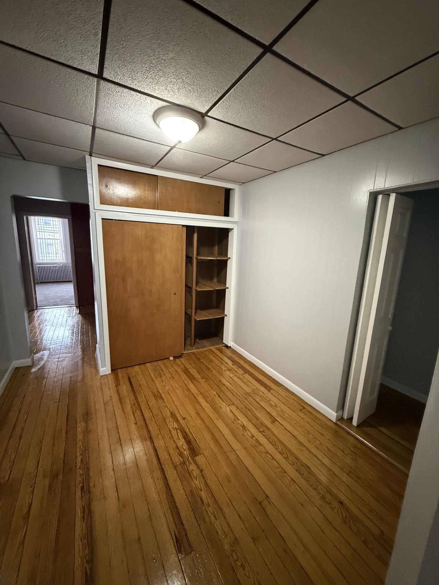 169 Beacon Avenue, Unit 2 Jersey City, NJ 07306 - Photo 5 of 9 a view of empty room with wooden floor