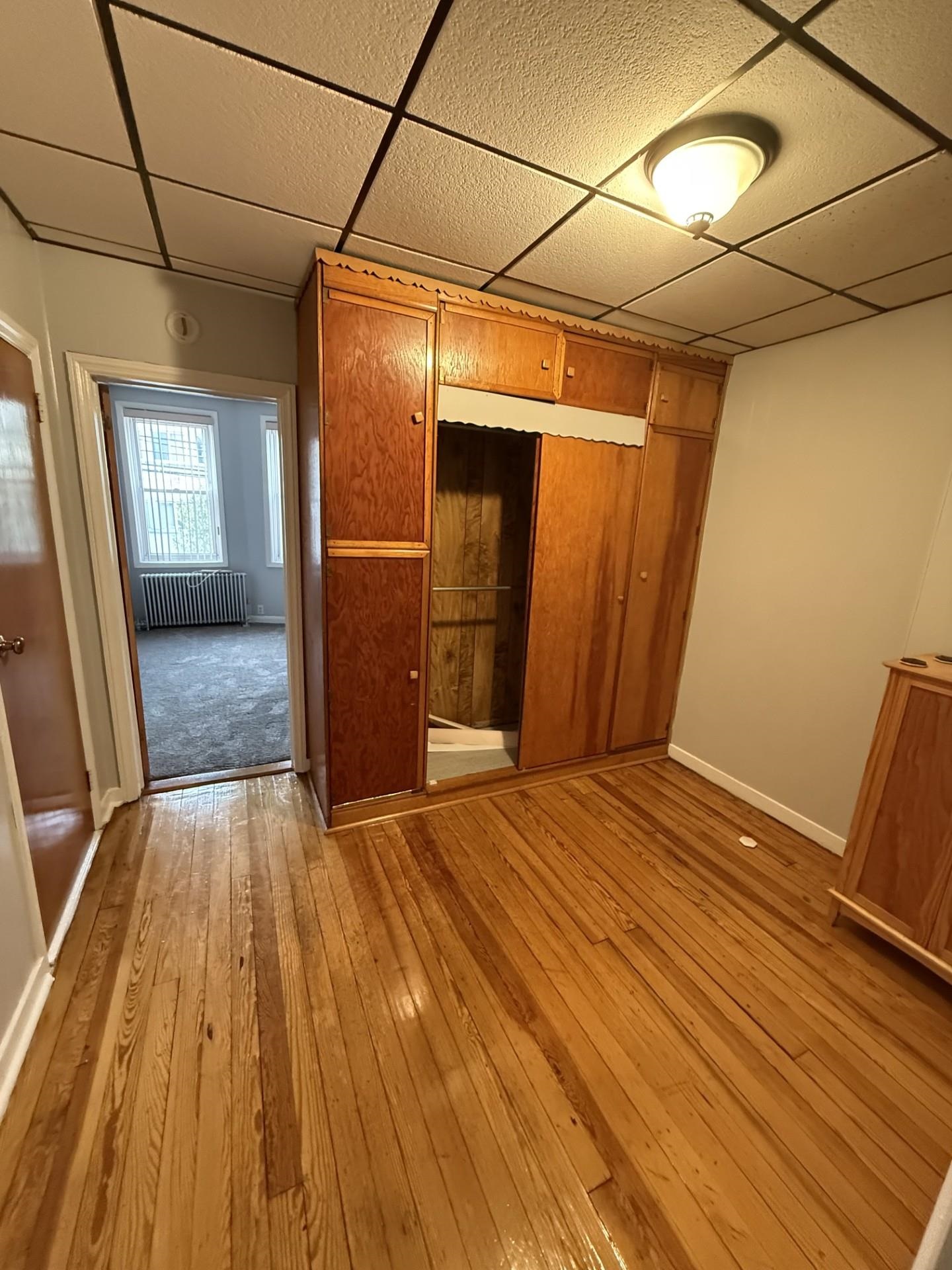 169 Beacon Avenue, Unit 2 Jersey City, NJ 07306 - Photo 6 of 9 a view of a room with wooden floor and stairs