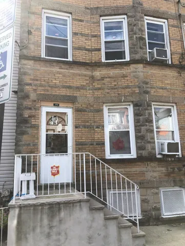 a view of a brick house with large windows