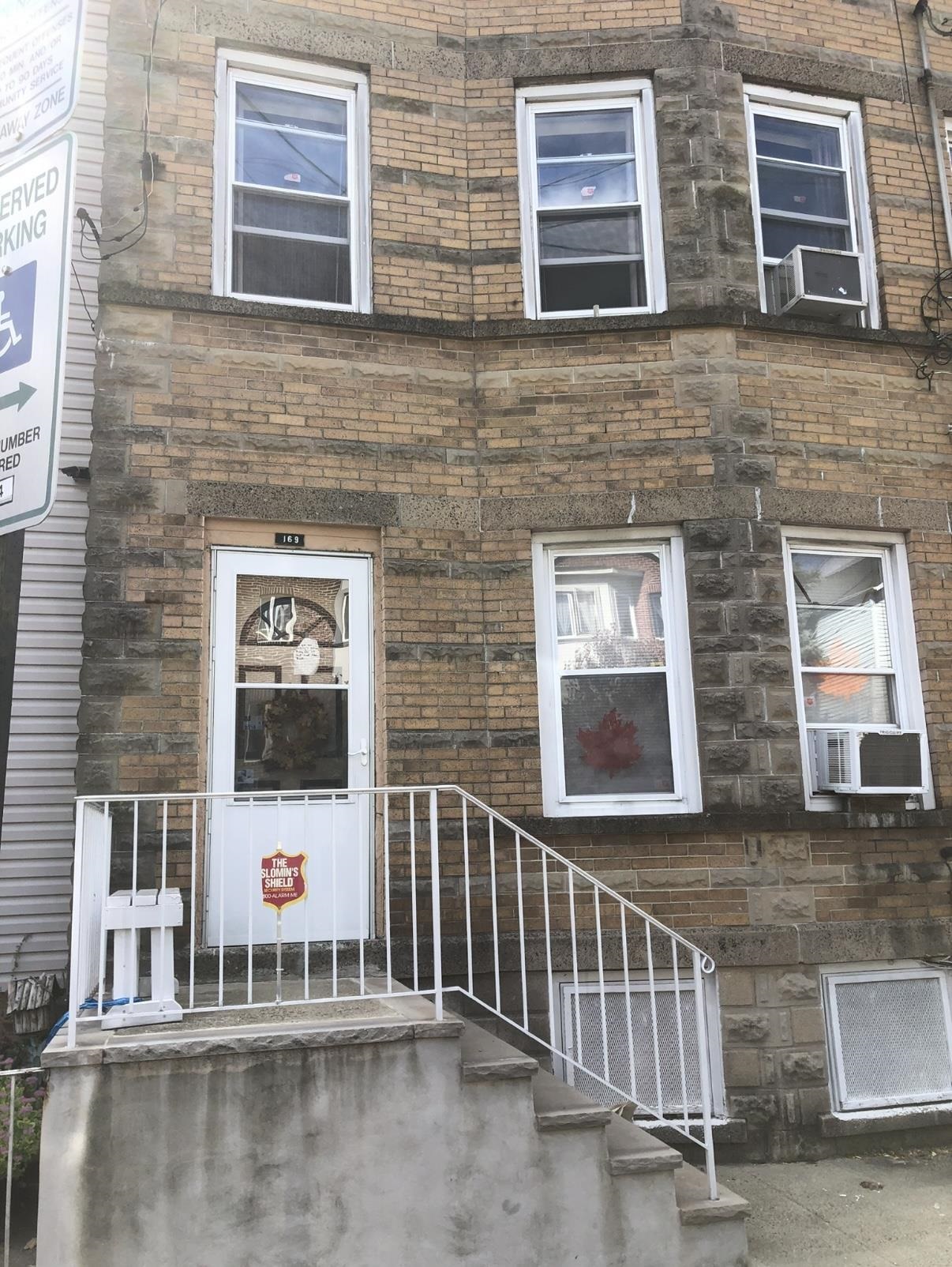 169 Beacon Avenue, Unit 2 Jersey City, NJ 07306 - Photo 9 of 9 a view of a brick house with large windows