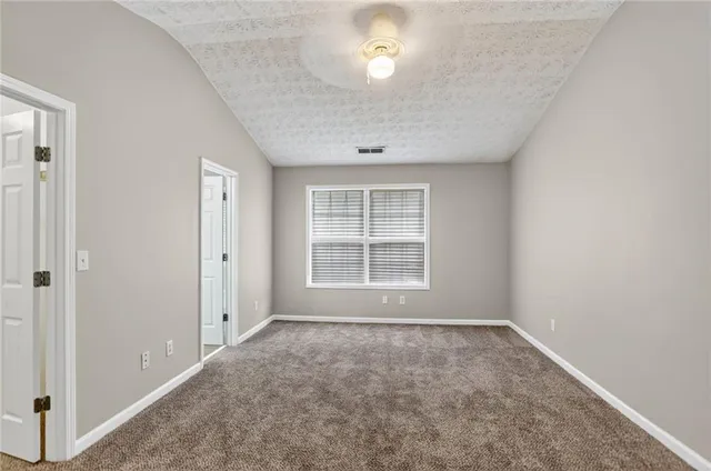 an empty room with a empty space and windows