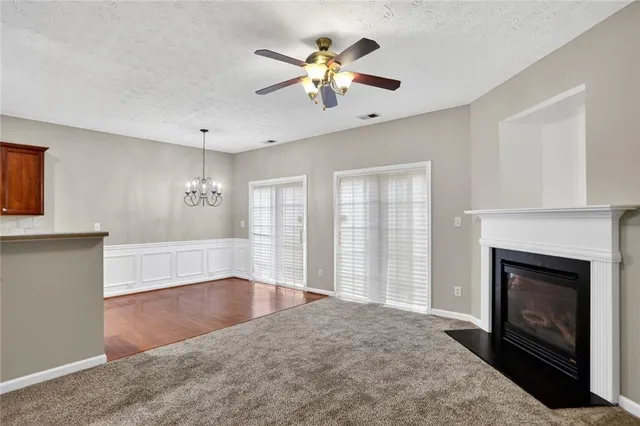 a view of an empty room with window and fireplace
