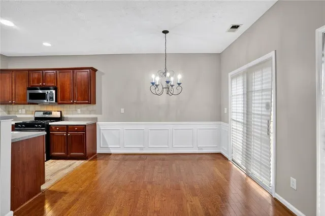 a kitchen with granite countertop stainless steel appliances and wooden cabinets