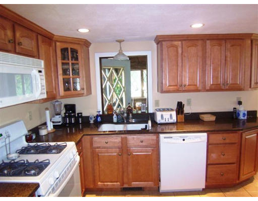 16 Governor Fuller Road Billerica, MA 01821 - Photo 4 of 21 a kitchen with stainless steel appliances granite countertop a stove a sink dishwasher and cabinets with wooden floor
