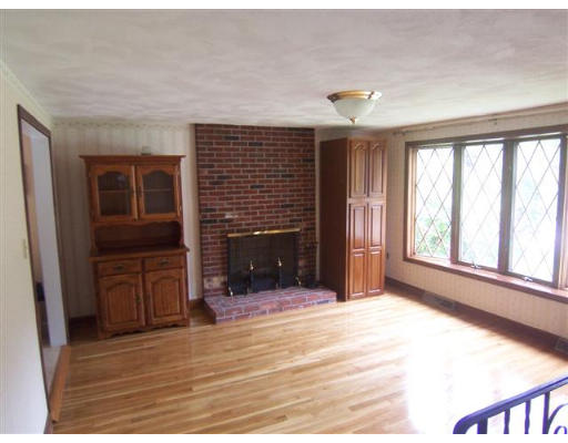 16 Governor Fuller Road Billerica, MA 01821 - Photo 7 of 21 a view of an empty room with a fireplace and a window