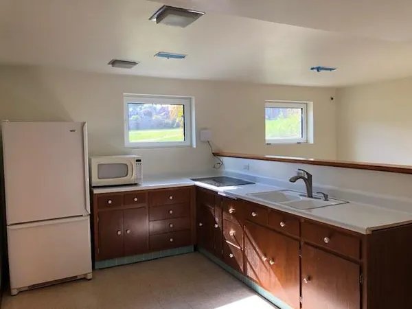 a kitchen with a sink and a refrigerator