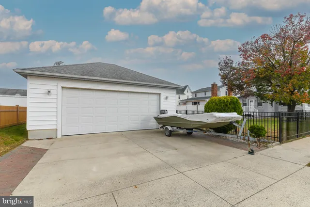 a view of a white house with a large tree and a yard
