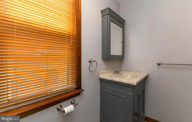 a bathroom with a toilet sink and window