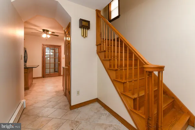 a bathroom with a granite countertop sink a toilet and a mirror