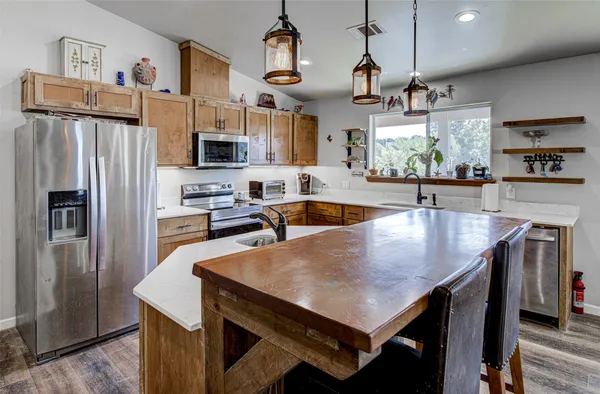 a kitchen with a table and refrigerator