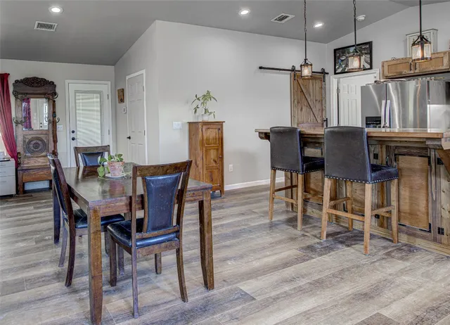a view of a dining room with furniture and wooden floor