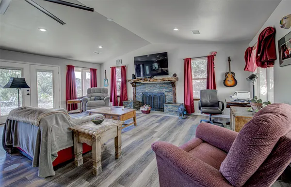 a living room with fireplace furniture and a flat screen tv
