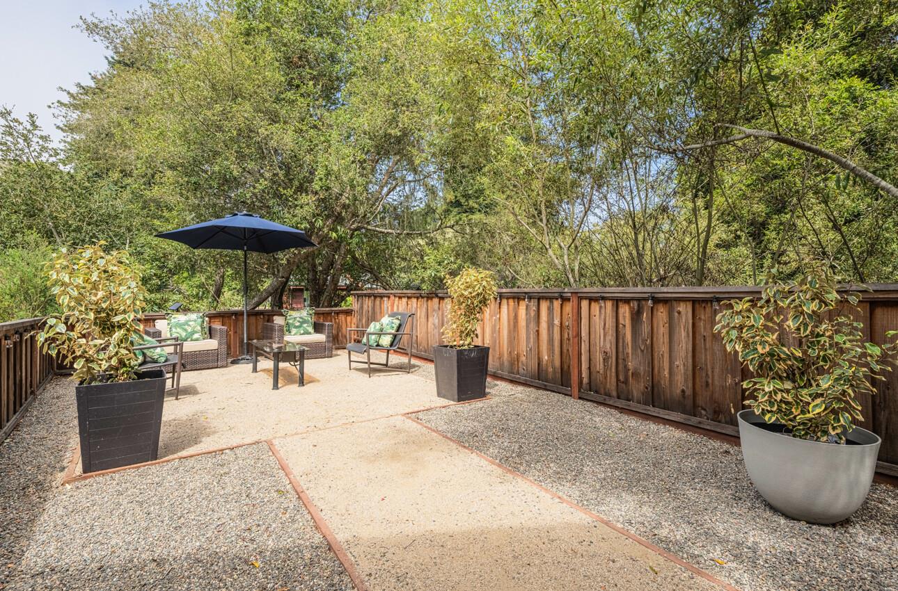 840 Seacliff Drive Aptos, CA 95003 - Photo 47 of 58 a view of a patio with table and chairs potted plants and covered with wooden fence