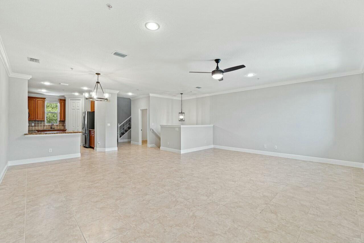 3016 Waterside Circle Boynton Beach, FL 33435 - Photo 7 of 50 an empty room with a ceiling fan and hardwood floor