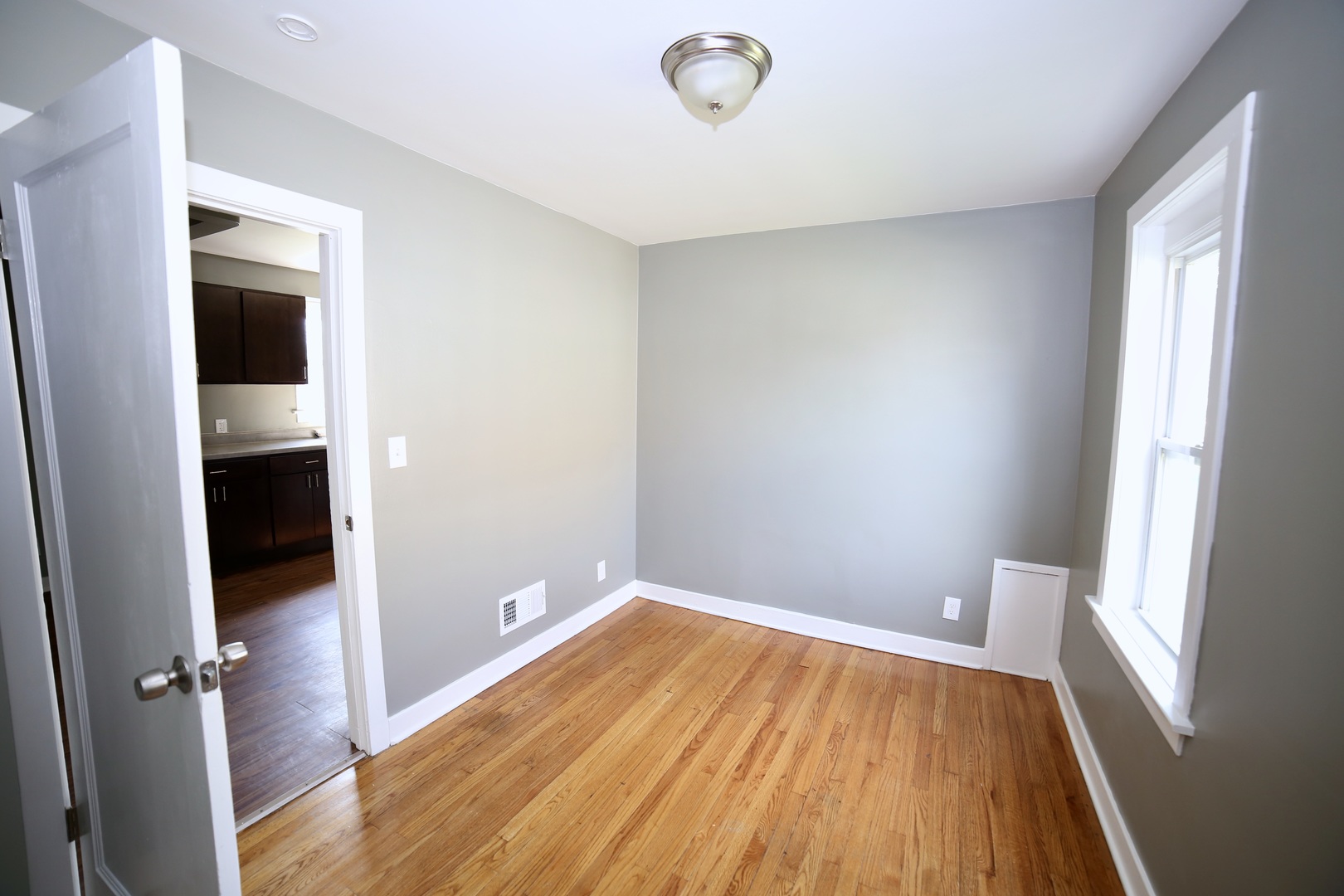 311 Pulaski Road Calumet City, IL 60409 - Photo 14 of 16 wooden floor in an empty room with a window