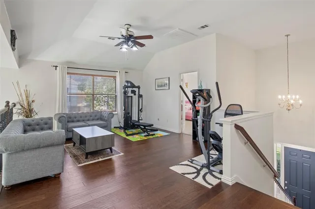 a view of a livingroom with furniture wooden floor and windows