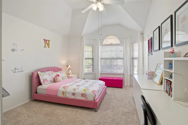 a bedroom with a bed furniture and a large window