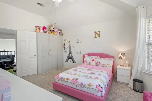 a bedroom with a bed and a dresser